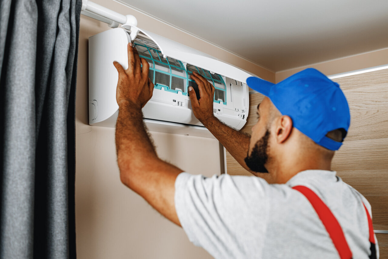 A technician performing AC Service in Everett, WA
