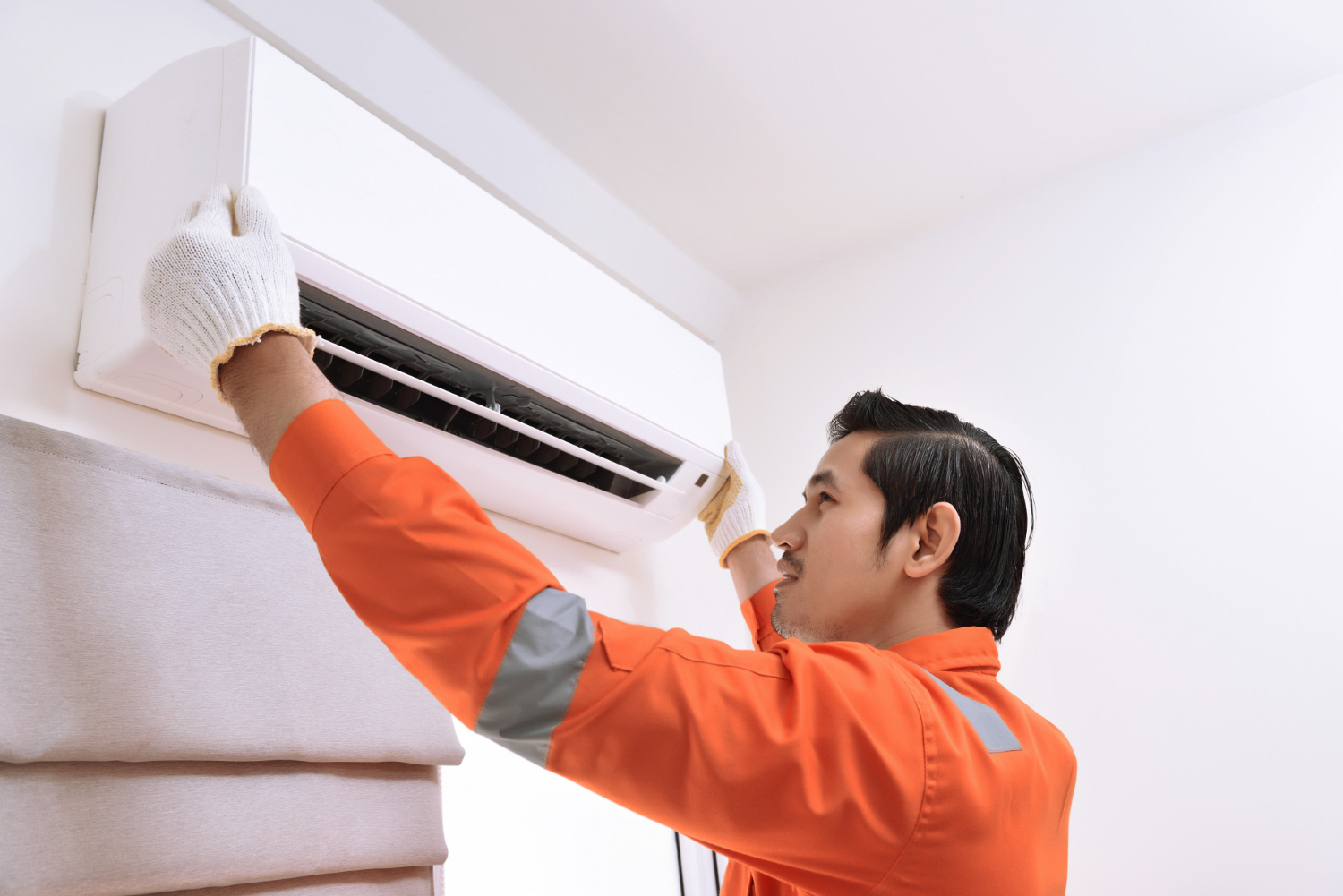 A technician performing indoor air quality service in Redmond, WA