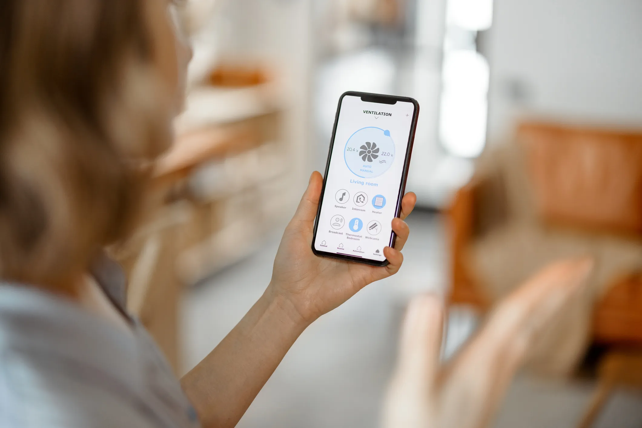 Person holding a smartphone with a home Indoor Air Quality Service app displayed in Sultan, WA.